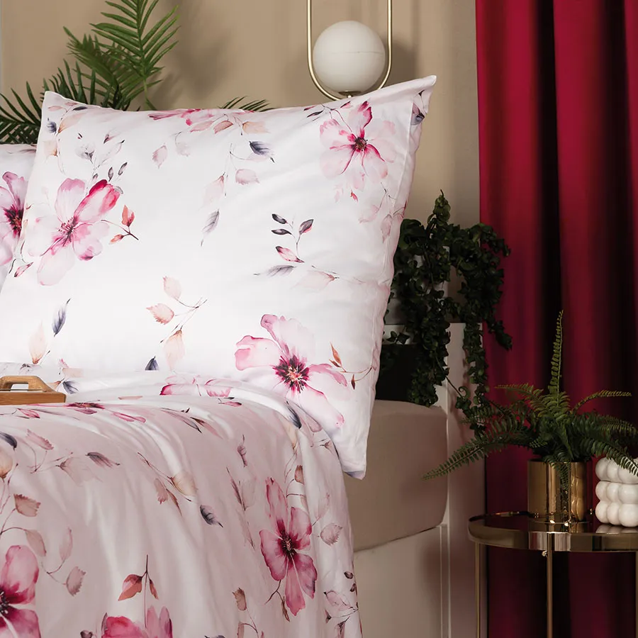 Elegancka pościel w pastelowych odcieniach różu na białym tle.